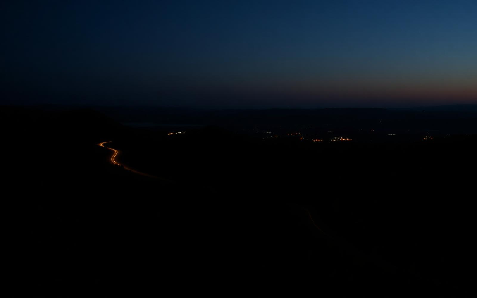 California highway winding through hills at dusk